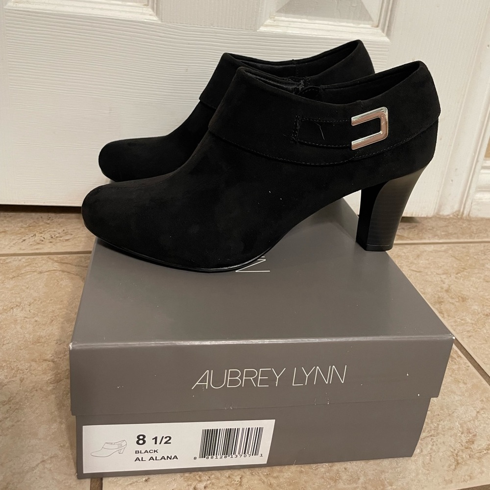 Aubrey Lynn Al Alana black suede booties with metal accent.